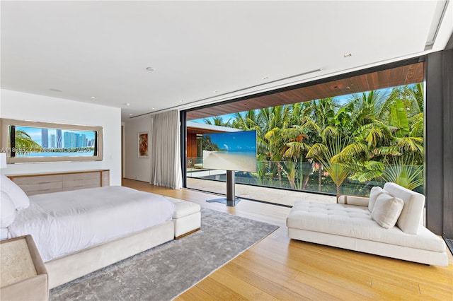 126 W San Marino Dr, Miami Beach, FL 33139 - bedroom featuring access to exterior, wood finished floors, expansive windows, and recessed lighting