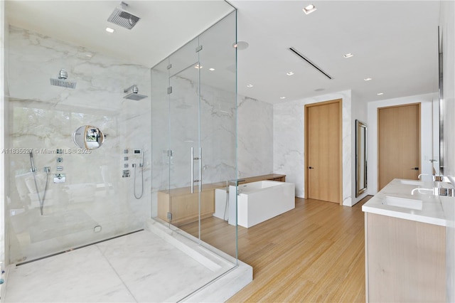 126 W San Marino Dr, Miami Beach, FL 33139 - full bath with a marble finish shower, a soaking tub, wood finished floors, and double vanity