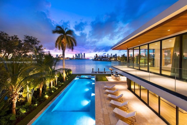126 W San Marino Dr, Miami Beach, FL 33139 - view of pool featuring a water view, a dock, boat lift, a pool with connected hot tub, and a city view