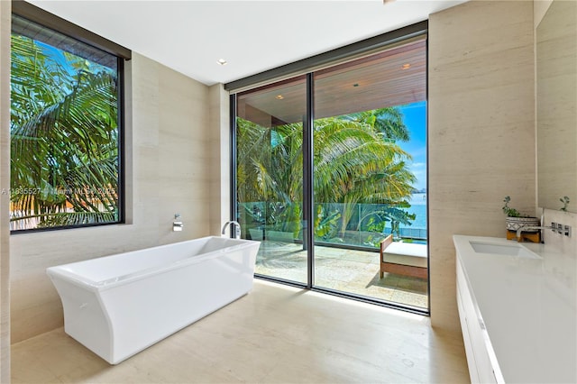 126 W San Marino Dr, Miami Beach, FL 33139 - bathroom featuring floor to ceiling windows and a soaking tub