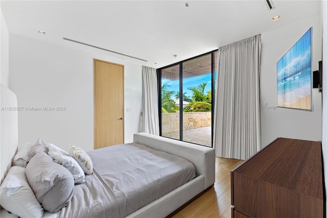 126 W San Marino Dr, Miami Beach, FL 33139 - bedroom with access to exterior and wood finished floors