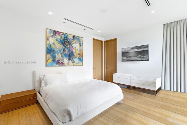 126 W San Marino Dr, Miami Beach, FL 33139 - bedroom with wood finished floors and recessed lighting