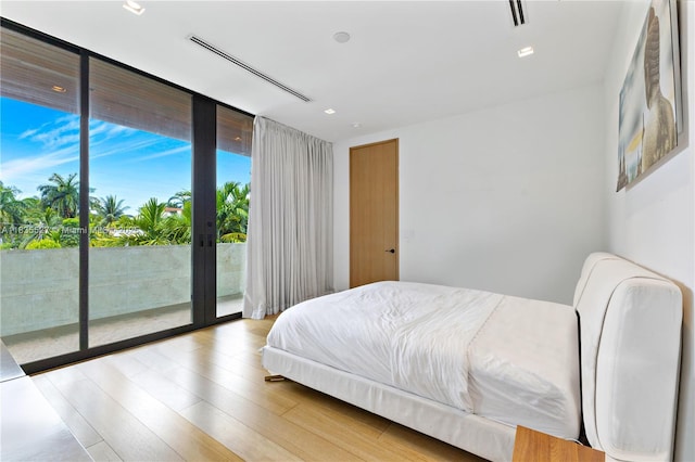 126 W San Marino Dr, Miami Beach, FL 33139 - bedroom featuring access to exterior, floor to ceiling windows, wood finished floors, french doors, and recessed lighting