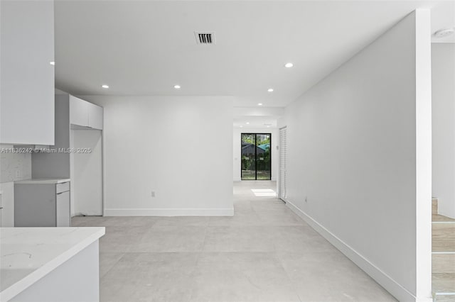1271 NW 38th St, Miami, FL 33142 - unfurnished living room with recessed lighting and concrete flooring