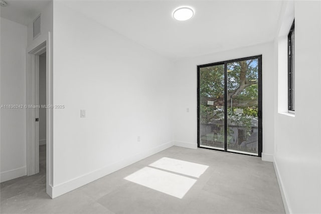 1271 NW 38th St, Miami, FL 33142 - spare room with baseboards and concrete floors