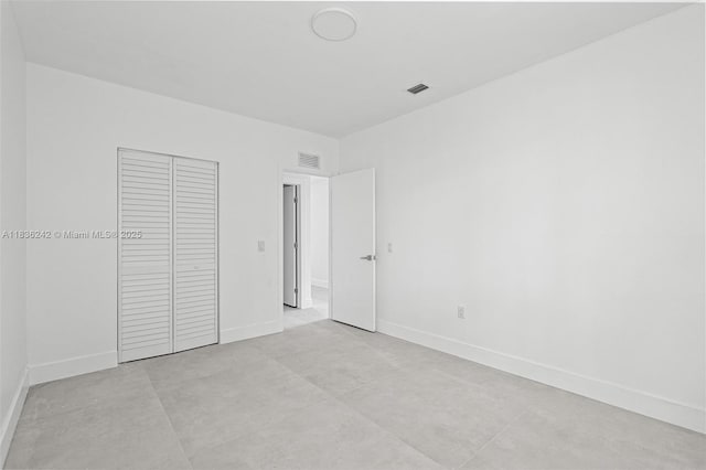 1271 NW 38th St, Miami, FL 33142 - unfurnished bedroom with a closet and concrete flooring