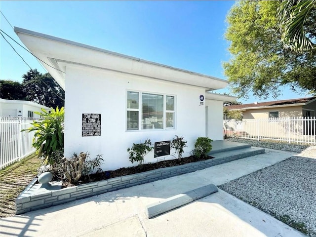 1130 NE 111th St, Biscayne Park, FL 33161 - view of front facade featuring stucco siding and a patio