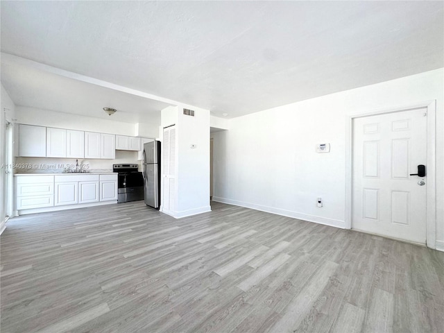 1130 NE 111th St, Biscayne Park, FL 33161 - unfurnished living room with light wood-style flooring and baseboards