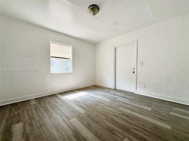 1130 NE 111th St, Biscayne Park, FL 33161 - unfurnished room with dark wood finished floors and baseboards