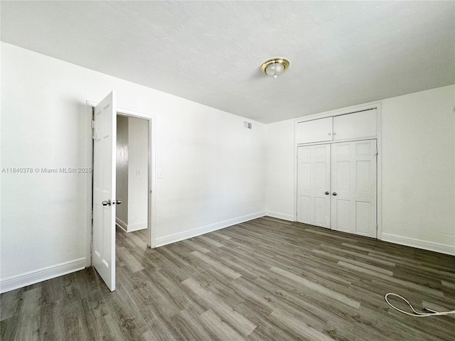 1130 NE 111th St, Biscayne Park, FL 33161 - unfurnished bedroom with wood finished floors and a closet