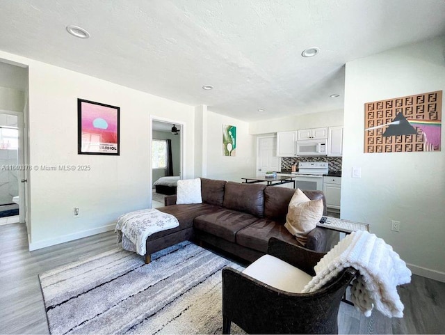 1130 NE 111th St, Biscayne Park, FL 33161 - living room featuring wood finished floors and recessed lighting