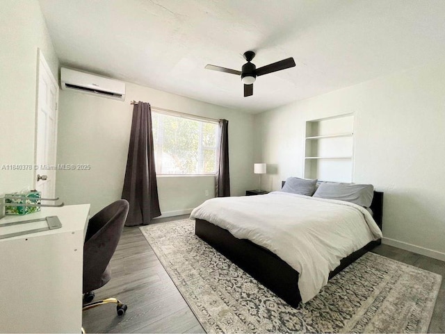 1130 NE 111th St, Biscayne Park, FL 33161 - bedroom with a wall mounted air conditioner, wood finished floors, and ceiling fan