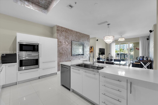 200 Sunny Isles Blvd Unit Th-404, Sunny Isles Beach, FL 33160 - kitchen with appliances with stainless steel finishes, light countertops, white cabinets, and decorative light fixtures