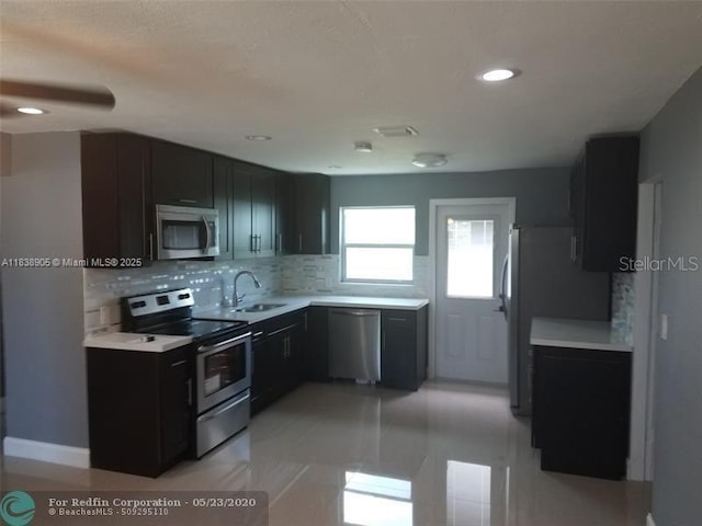 1610 S 22nd Ave, Hollywood, FL 33020 - kitchen with appliances with stainless steel finishes, light countertops, backsplash, dark cabinets, and recessed lighting