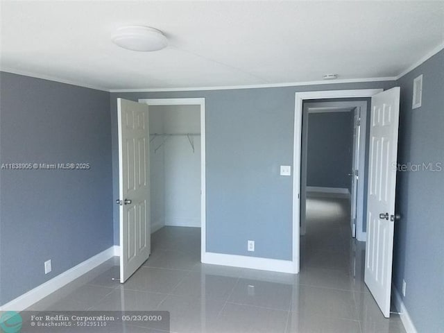 1610 S 22nd Ave, Hollywood, FL 33020 - unfurnished bedroom with ornamental molding and tile patterned floors