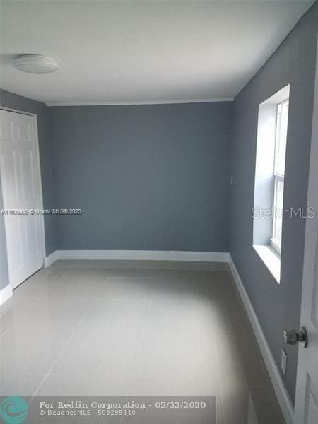 1610 S 22nd Ave, Hollywood, FL 33020 - tiled empty room with baseboards