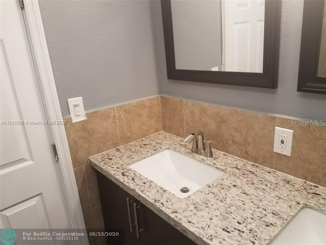 1610 S 22nd Ave, Hollywood, FL 33020 - bathroom featuring vanity, tile walls, and backsplash