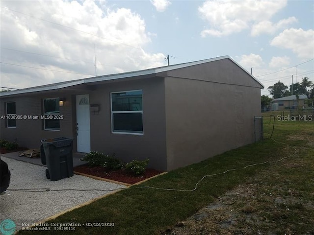 1610 S 22nd Ave, Hollywood, FL 33020 - view of side of home with stucco siding and a lawn