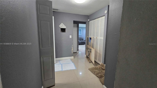 1610 S 22nd Ave, Hollywood, FL 33020 - hall featuring a textured wall and light tile patterned floors
