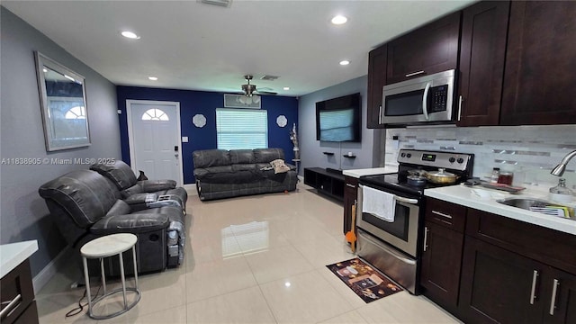 1610 S 22nd Ave, Hollywood, FL 33020 - kitchen featuring appliances with stainless steel finishes, open floor plan, ceiling fan, light countertops, and decorative backsplash