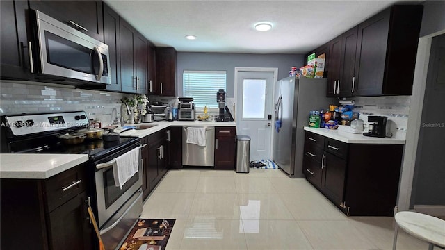 1610 S 22nd Ave, Hollywood, FL 33020 - kitchen featuring appliances with stainless steel finishes, tasteful backsplash, and light countertops
