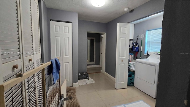 1610 S 22nd Ave, Hollywood, FL 33020 - hall featuring washer / clothes dryer, light tile patterned floors, and a textured ceiling