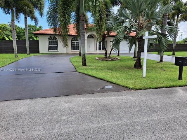 16961 SW 213th Ln, Miami, FL 33187 - view of front of property featuring concrete driveway, stucco siding, and a tile roof