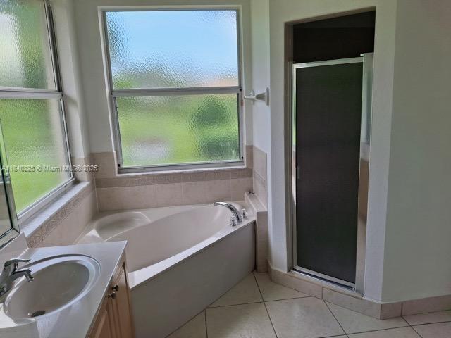 16961 SW 213th Ln, Miami, FL 33187 - bathroom featuring vanity, a shower stall, a garden tub, and tile patterned flooring