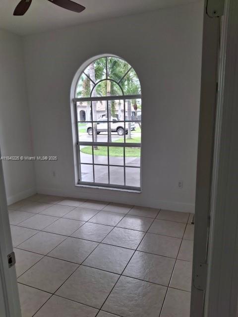 16961 SW 213th Ln, Miami, FL 33187 - empty room featuring light tile patterned floors and ceiling fan