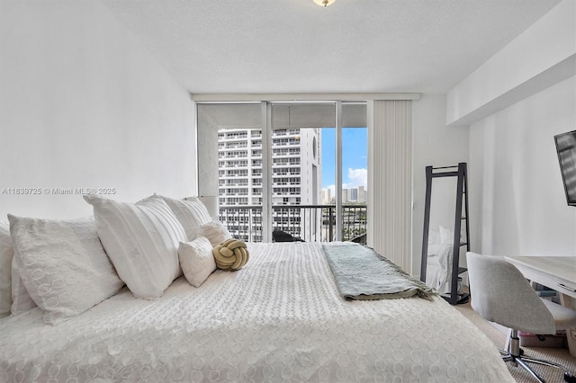 1750 SE Bayshore Dr Unit 2506, Miami, FL 33132 - bedroom with access to exterior, a textured ceiling, and expansive windows