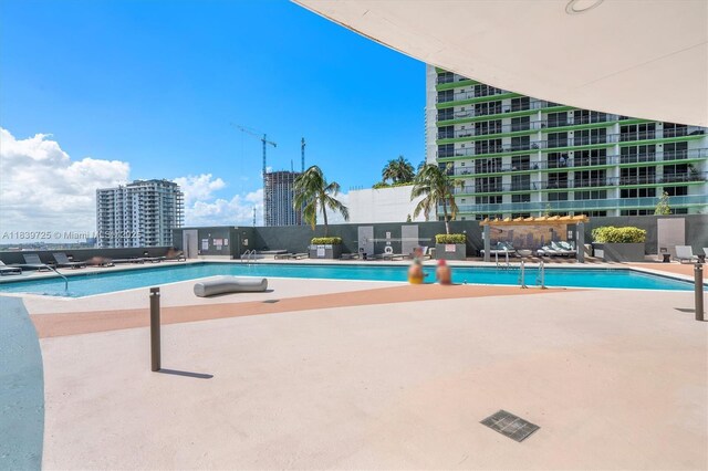 1750 SE Bayshore Dr Unit 2506, Miami, FL 33132 - community pool featuring a patio area