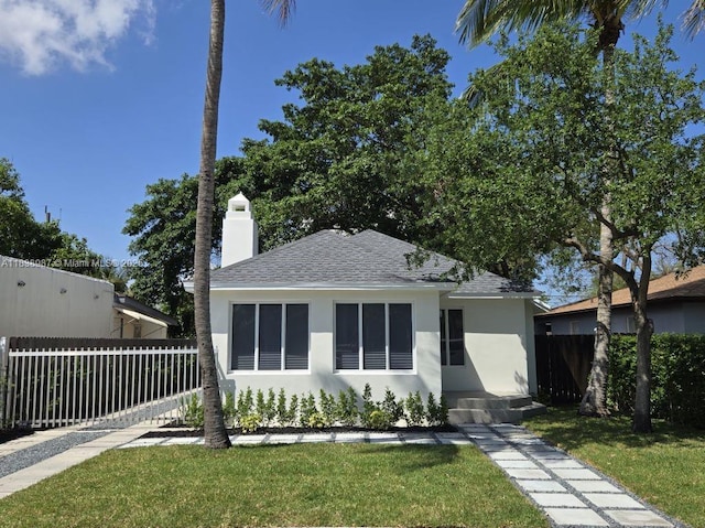 1923 NW 48th St, Miami, FL 33142 - view of front of house featuring stucco siding, a shingled roof, and a chimney