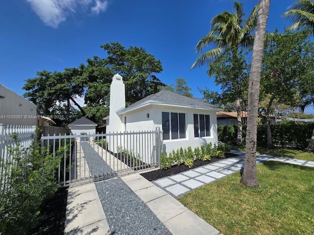 1923 NW 48th St, Miami, FL 33142 - bungalow-style house featuring a chimney, stucco siding, a gate, and roof with shingles