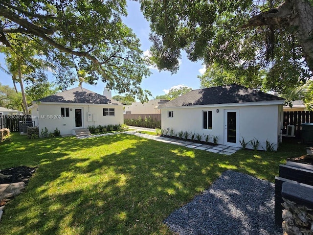1923 NW 48th St, Miami, FL 33142 - rear view of property with stucco siding, entry steps, and roof with shingles