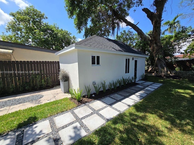 1923 NW 48th St, Miami, FL 33142 - view of side of property featuring stucco siding and a shingled roof