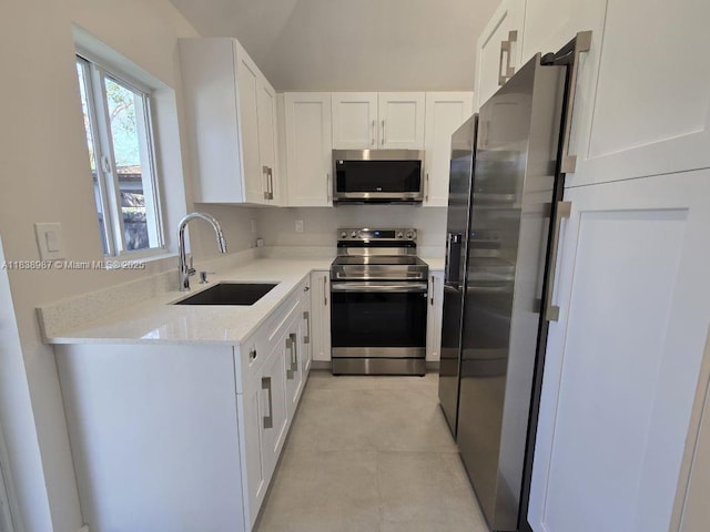 1923 NW 48th St, Miami, FL 33142 - kitchen with appliances with stainless steel finishes, white cabinets, light stone countertops, light tile patterned floors, and lofted ceiling