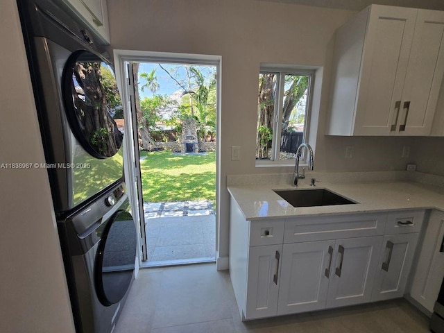 1923 NW 48th St, Miami, FL 33142 - laundry area featuring stacked washing machine and dryer and cabinet space