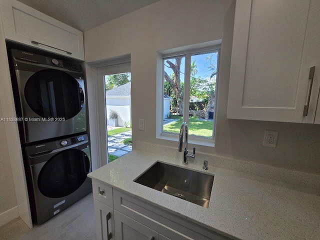 1923 NW 48th St, Miami, FL 33142 - laundry area with stacked washer / dryer and a sink