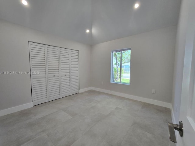1923 NW 48th St, Miami, FL 33142 - unfurnished bedroom featuring lofted ceiling, recessed lighting, a closet, and concrete floors