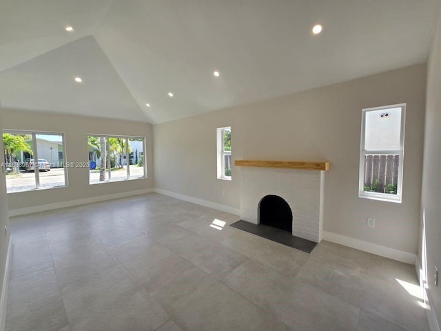 1923 NW 48th St, Miami, FL 33142 - unfurnished living room featuring healthy amount of natural light, recessed lighting, a brick fireplace, and high vaulted ceiling