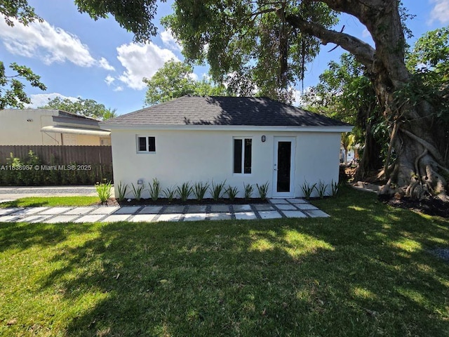 1923 NW 48th St, Miami, FL 33142 - back of property with stucco siding and a shingled roof