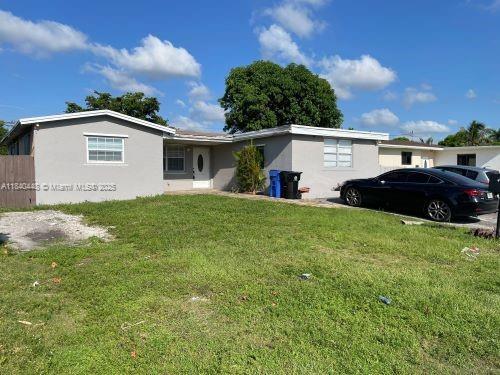 433 SW 28th Ave, Fort Lauderdale, FL 33312 - view of front of home featuring a front lawn and stucco siding