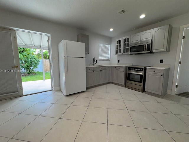 433 SW 28th Ave, Fort Lauderdale, FL 33312 - kitchen featuring appliances with stainless steel finishes, gray cabinetry, glass insert cabinets, recessed lighting, and light countertops