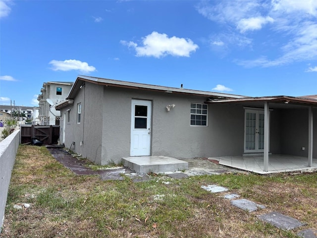433 SW 28th Ave, Fort Lauderdale, FL 33312 - rear view of property with stucco siding, french doors, and a patio