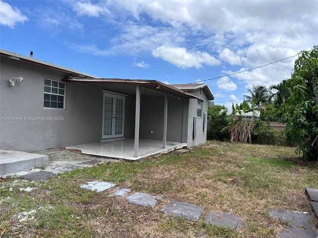 433 SW 28th Ave, Fort Lauderdale, FL 33312 - rear view of house with french doors, stucco siding, a patio, and a yard