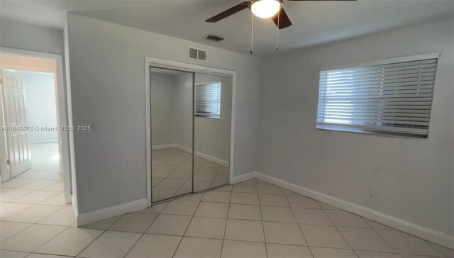 433 SW 28th Ave, Fort Lauderdale, FL 33312 - unfurnished bedroom featuring tile patterned flooring, a closet, and a ceiling fan