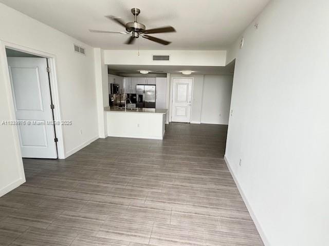 1776 SW Polk St Unit 1412, Hollywood, FL 33020 - unfurnished living room featuring a ceiling fan and baseboards