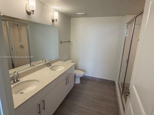 1776 SW Polk St Unit 1412, Hollywood, FL 33020 - bathroom featuring a stall shower, double vanity, and wood finished floors