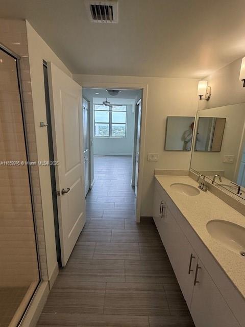 1776 SW Polk St Unit 1412, Hollywood, FL 33020 - full bath featuring a stall shower, double vanity, and wood finished floors