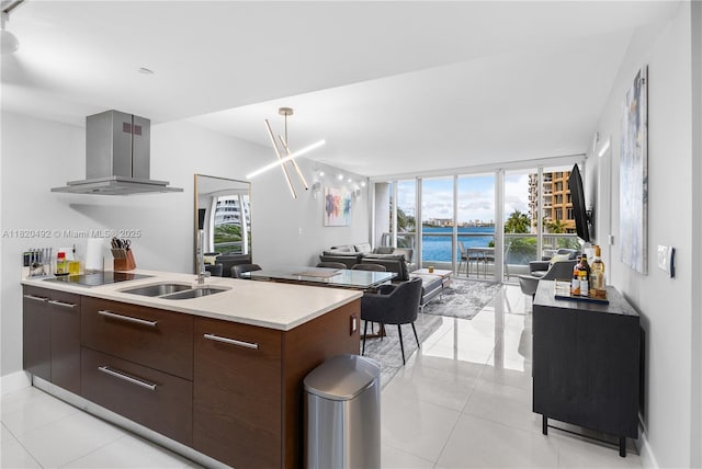 465 Brickell Ave Unit 417, Miami, FL 33131 - kitchen with ventilation hood, modern cabinets, light countertops, black electric stovetop, and plenty of natural light